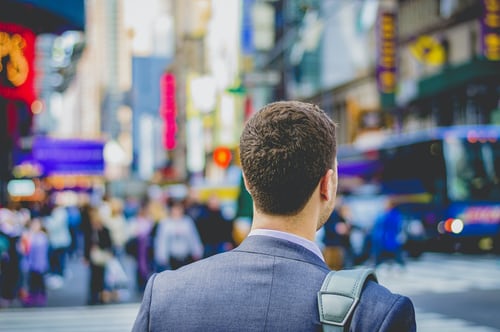 Person standing in city with brief case 